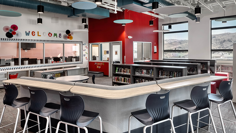 Middle school library and collaboration space with book shelves and work spaces